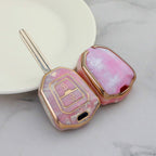 Isuzu Autoschlüsseletui, goldfarben mit Jade-Einlage